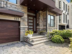 Toronto (Newtonbrook East) apartment for rent - A stone house with a brown garage door numbered 133.
