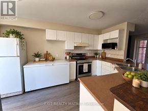 Ottawa townhouse for rent - A kitchen with white appliances and wooden countertops.
