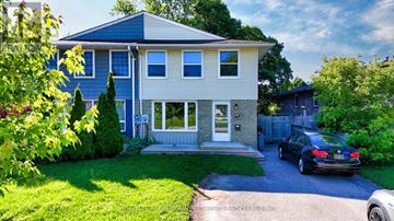 Barrie (Cundles East) apartment for rent - A house with a blue roof and white walls is surrounded by greenery.