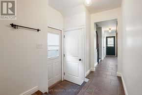 Barrie (Cundles East) apartment for rent - A hallway with a white door and a black railing.