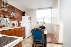 Burlington (Roseland) condo for rent - A kitchen with a table and chairs in front of a window.
