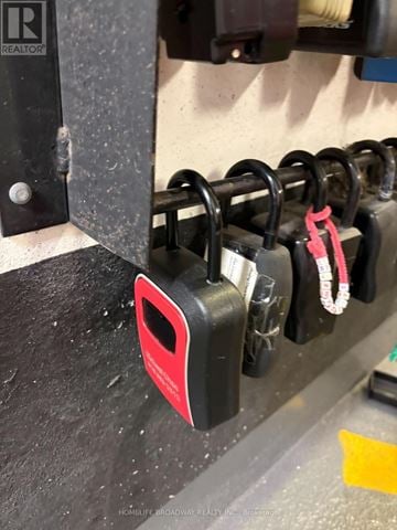 Toronto (Henry Farm) condo for rent - A red padlock is hanging on a black metal hook.