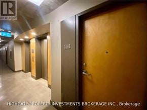 Toronto (Waterfront Communities) condo for rent - A hallway with doors and a sign that says Brokerage.