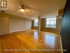 Toronto (Waterfront Communities) condo for rent - A spacious room with wooden flooring and a ceiling fan.