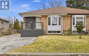 Pickering (Bay Ridges) apartment for rent - A house with a brown roof and a grey garage door.