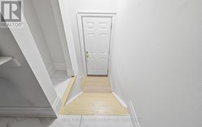 Pickering (Bay Ridges) apartment for rent - A white door is in a hallway with a wooden floor.
