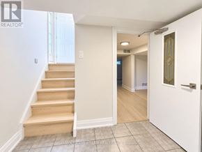 Pickering (Bay Ridges) apartment for rent - A hallway with a staircase leading to a second floor.