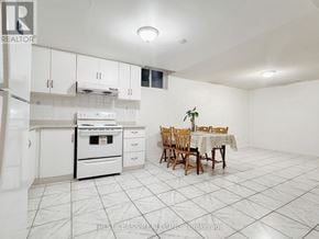 Markham (Milliken Mills East) apartment for rent - A white kitchen with a dining table set up.