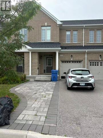 Aurora townhouse for rent - A car is parked in front of a house.