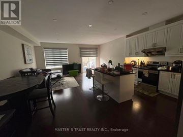 Aurora townhouse for rent - A kitchen with a dining table and chairs in the middle of the room.