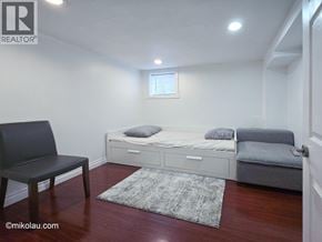 Burnaby apartment for rent - A bedroom with a bed, chair, and rug.