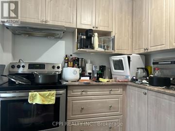 Toronto (L'amoreaux) apartment for rent - A kitchen with wooden cabinets and a stove top oven.