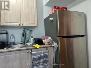 Toronto (L'amoreaux) apartment for rent - A kitchen with a refrigerator, sink, and cabinets.