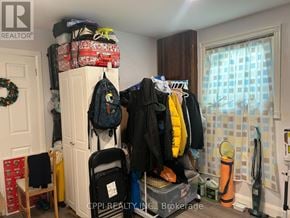Toronto (L'amoreaux) apartment for rent - A room with a white door and a window with a blue and white checkered curtain.