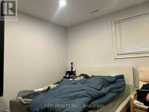 Toronto (L'amoreaux) apartment for rent - A bedroom with a bed, nightstand, and window with blinds.