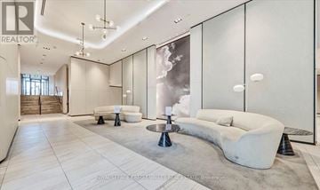 Pickering (Bay Ridges) condo for rent - A modern living room with a white sofa and a glass wall.