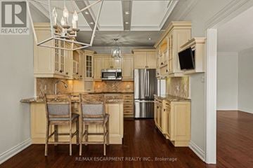 Burlington (Bayview) townhouse for rent - A kitchen with wooden cabinets and a granite countertop.
