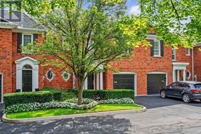 Burlington (Bayview) townhouse for rent - A red brick house with a tree in front.