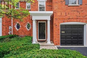 Burlington (Bayview) townhouse for rent - A red brick house with a black door and windows.