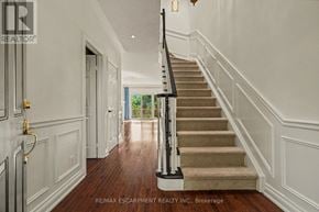 Burlington (Bayview) townhouse for rent - A staircase with a beige carpet and a black railing.