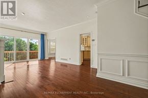Burlington (Bayview) townhouse for rent - A room with wooden floors and white walls, with a doorway leading to another room.