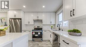 Kitchener apartment for rent - A modern kitchen with white cabinets and a stainless steel refrigerator.