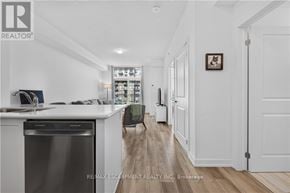 Hamilton (Waterdown) condo for rent - A modern kitchen with white cabinets and a stainless steel dishwasher.