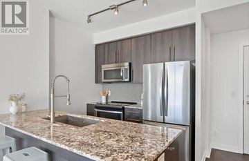 Mississauga (Creditview) condo for rent - A modern kitchen with granite countertops and stainless steel appliances.