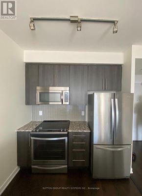 Mississauga (Creditview) condo for rent - A modern kitchen with stainless steel appliances and a black countertop.