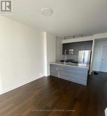 Mississauga (Creditview) condo for rent - A kitchen area with a counter and a fridge.