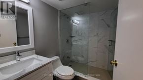 Toronto (Waterfront Communities) condo for rent - A bathroom with a sink, toilet, and shower.