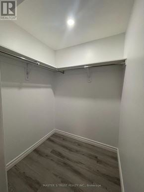 Toronto (Agincourt North) apartment for rent - A brokerage closet with a wooden floor and white walls.