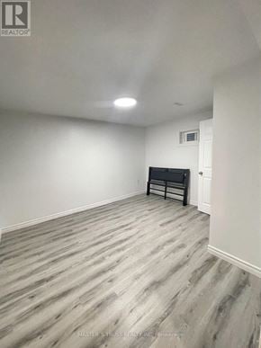 Toronto (Agincourt North) apartment for rent - A room with a wooden floor and a black piano.