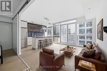 Ottawa condo for rent - A living room with a brown leather couch and a coffee table.