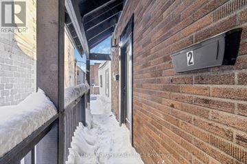 Ottawa apartment for rent - A snow-covered balcony with a brick wall and a sign that reads "2".