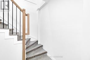 Ottawa apartment for rent - A staircase with a wooden handrail and metal balusters.