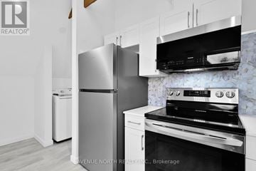 Ottawa apartment for rent - A modern kitchen with a stainless steel refrigerator and oven.