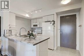 Toronto (Eglinton East) condo for rent - A kitchen with a marble countertop and stainless steel appliances.