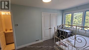 Toronto (Pleasant View) apartment for rent - A bedroom with a bed, dresser, and window.