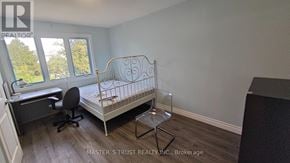 Toronto (Pleasant View) apartment for rent - A bedroom with a metal bed frame and a desk with a chair.