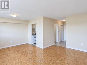 Toronto (Eglinton East) condo for rent - A room with a wooden floor and a small kitchenette.