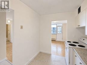 Toronto (Eglinton East) condo for rent - A white kitchen with a stove top oven and a window.