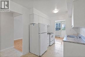 Toronto (Eglinton East) condo for rent - A kitchen with white appliances and cabinets.