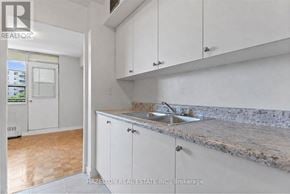 Toronto (Eglinton East) condo for rent - A kitchen with white cabinets and a marble countertop.