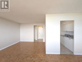 Toronto (Eglinton East) condo for rent - A room with a kitchen area visible through the doorway.