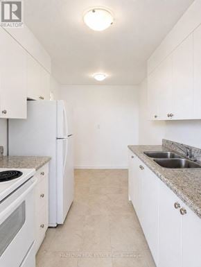 Toronto (Eglinton East) condo for rent - A kitchen with white cabinets and appliances.