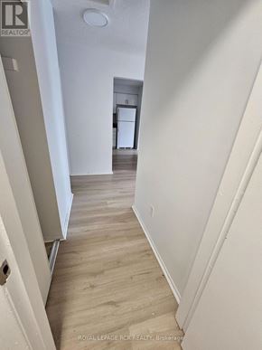 Aurora (Hills Of St Andrew) multi-family for rent - A hallway with wood flooring and white walls.