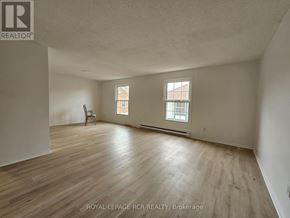 Aurora (Hills Of St Andrew) multi-family for rent - A room with wooden flooring and two windows.