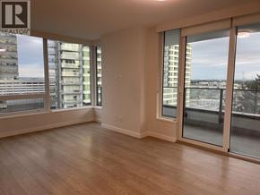 Vancouver apartment for rent - A large empty room with wooden floors and sliding glass doors.