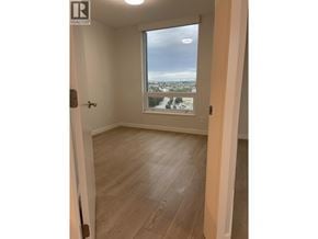 Vancouver apartment for rent - A room with a view of the city through a window.